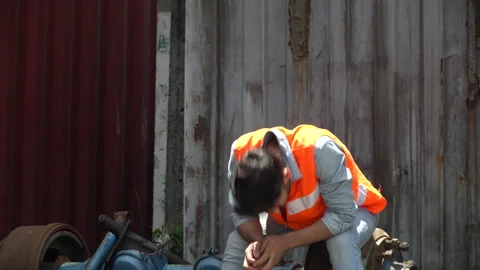 Furious young worker about to throw and break helmet and face mask at workpla Stock Footage 145206918