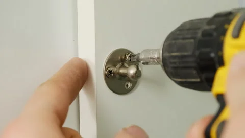 Furniture assembler install screw to attach door handle surface Stock Footage 316187096