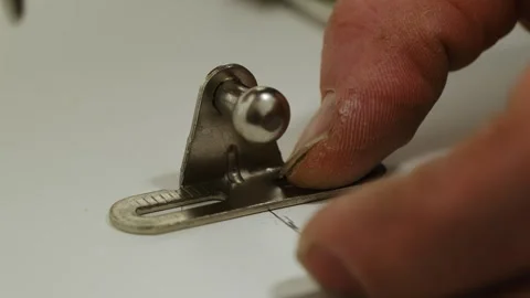Furniture assembler installs hinge carefully touching element Stock Footage 316186855
