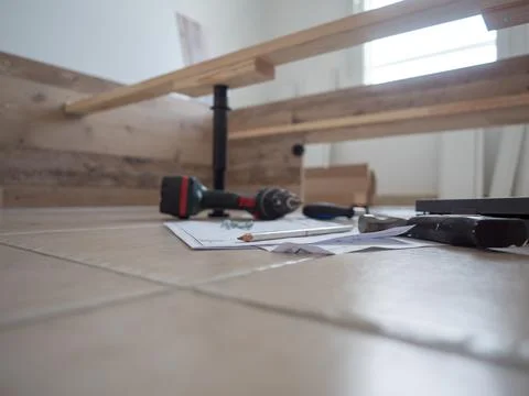 Furniture - assembling the bed, lying tools and wooden elements needed for wo Stock Photos