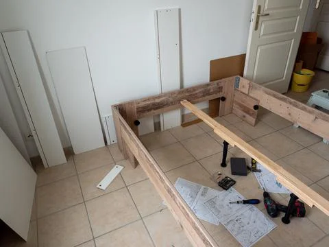 Furniture - assembling the bed, lying tools and wooden elements needed for wo Stock Photos