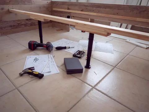 Furniture - assembling the bed, lying tools and wooden elements needed for wo Stock Photos