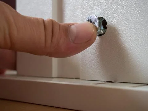 Furniture assembly concept. guy assembles wardrobe close up Stock Photos