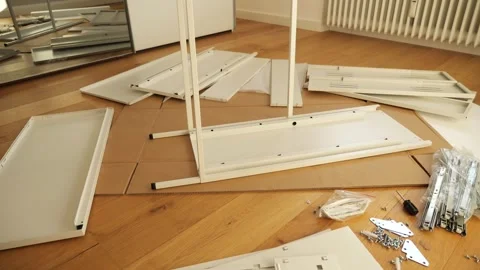 Furniture assembly tools and hardware laid out on wooden floor Stock Footage 319406587