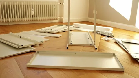 Furniture assembly tools and hardware laid out on wooden floor Stock Footage 319406615