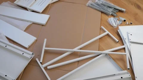 Furniture assembly tools and hardware laid out on wooden floor Stock Footage 319406995