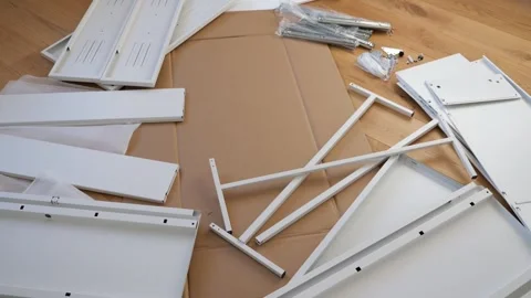 Furniture assembly tools and hardware laid out on wooden floor Stock Footage 319407028