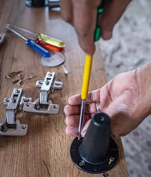 Furniture assembly. Work tool and components. Male Carpenter at work Stock Photos