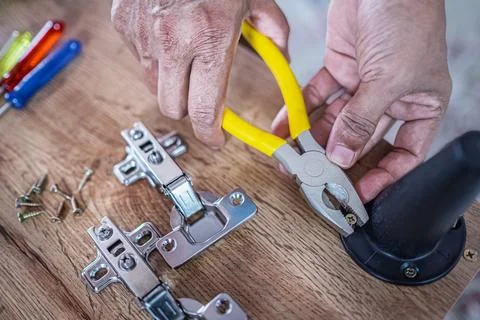 Furniture assembly. Work tool and components. Male Carpenter at work Stock Photos
