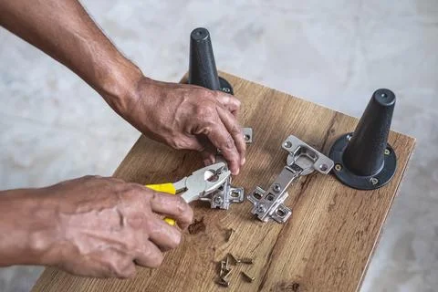 Furniture assembly. Work tool and components. Male Carpenter at work Stock Photos