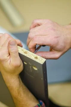 Furniture assembly. Worker assembling a wardrobe Stock Photos