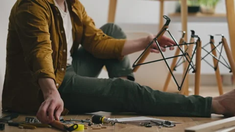 Furniture expert, Engineer Studying instructions for furniture assembly whil Stock Footage 323707232