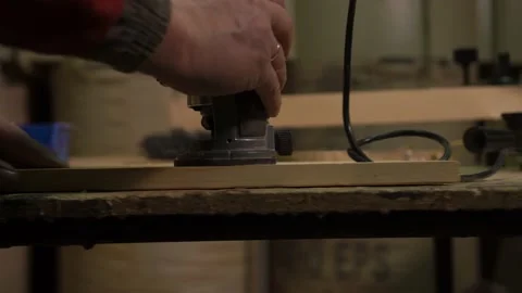 A furniture factory worker processes a block of wood for a set of products Stock Footage 149123389