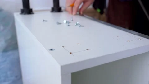 The furniture maker draws using a ruler and pencil on the cabinet body. Stock Footage 150244083