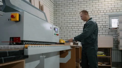 The furniture maker edges the edge of the part on a special stationary machine Stock Footage 219729157