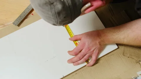 Furniture maker ensures accuracy by using tape measure Stock Footage 304402243