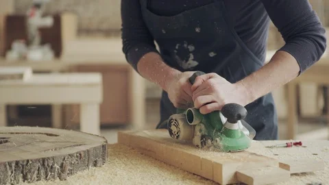 Furniture maker using electric flatbed sander Stock Footage 105185627