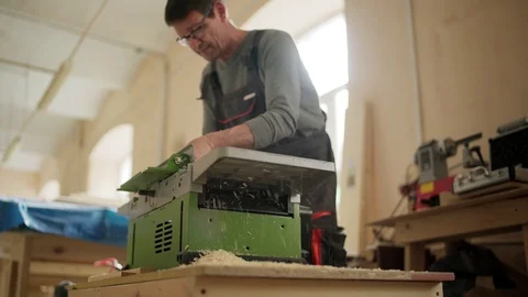 Furniture maker using electric planing machine Stock Footage 101795204