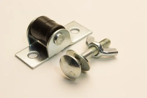 Furniture tie for attaching two elements and a stop roller for pull-out struc Foto stock