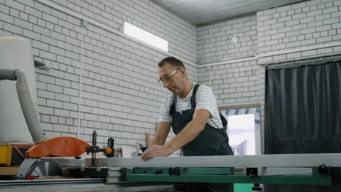 Furniture Workshop.- Working behind an electric stationary saw Stock Footage 219726433