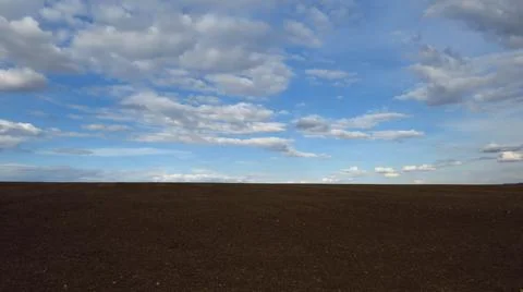 Furrows row pattern in a plowed field prepared for planting crops in spring.  Stock Photos