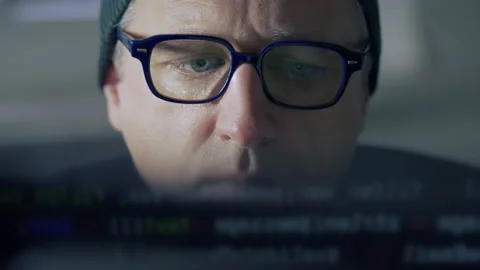 Furtive man hacking into a computer in close up Stock Footage 167170331