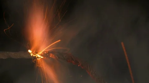 Fuse burns quickly with sparks and smoke on a black background Stock Footage 69908297