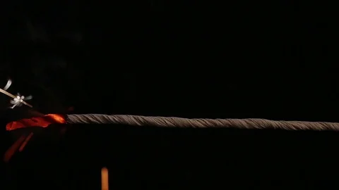 Fuse lights up on a black background. Bomb Stock Footage 79307054