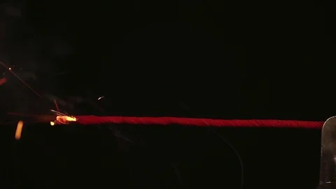 Fuse lights up on a black background. Sparks and smoke. Bomb Stock Footage 79307064