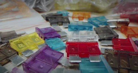 Fuses to protect the equipment. Macro Soft focus. Close-up. Hand Picking a Red Stock Footage 311027941