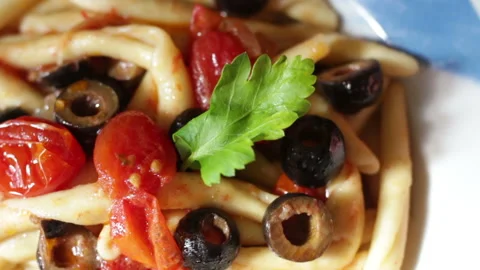 Fusilli al ferro with black olives and cherry tomatoes on wood background Stock Footage 149245223