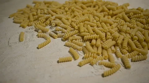 Fusilli Bucati Corti and flour on a wooden background Video stock 142174194
