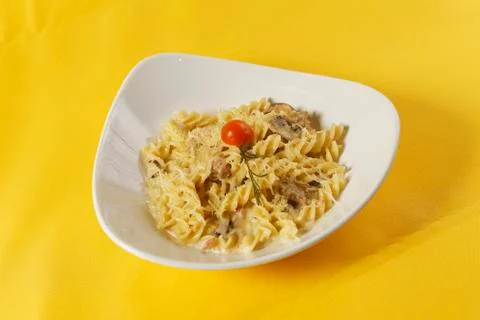 Fusilli or pasta spirals with ham, mushrooms and cherry tomato Stock-Fotos
