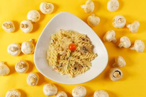 Fusilli or pasta spirals with ham, mushrooms and cherry tomato Stock Photos