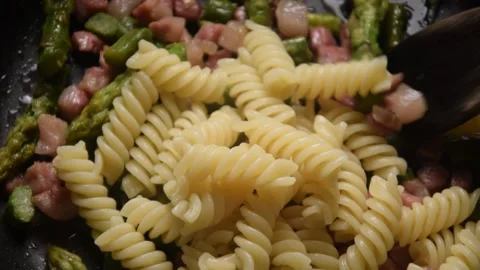 Fusilli with pancetta and asparagus Stock Footage 131485292