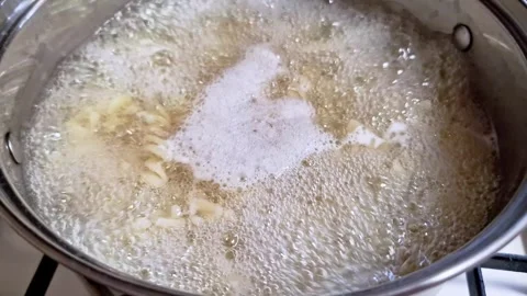 Fusilli Pasta Bubbling in Rapidly Boiling Water Stock Footage 325222533