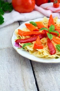 Fusilli pasta with cherry tomatoes, basil and peppers cheese, top view, copy Stock Photos