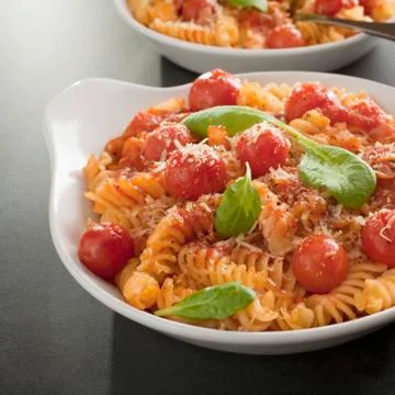 Fusilli pasta with cherry tomatoes, parmesan and ricotta square Stock Photos