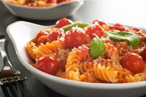 Fusilli pasta with cherry tomatoes, parmesan and ricotta Stock Photos