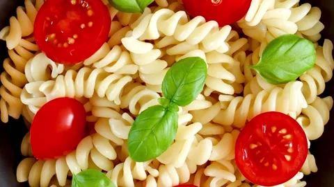 Fusilli pasta cooked with tomatoes and basil Stock-Footage 221983584