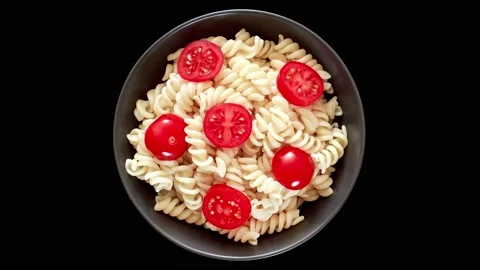 Fusilli pasta cooked with tomatoes, in bowl, top view 動画素材 207806571