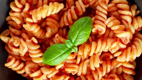 Fusilli pasta cooked with tomatoes sauce and basil Stock Footage 228808920