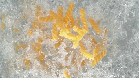 Fusilli Pasta Falling into Pot of Boiling Water Stock Footage 271398142