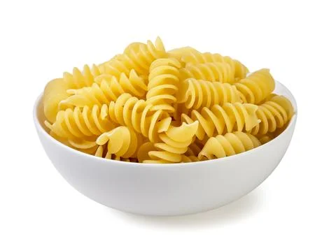 Fusilli pasta in a plate close-up on a white background. Isolated Stock Photos