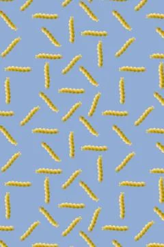 Fusilli pasta random flat lay on blue background without shadow. can be used as Stock Photos