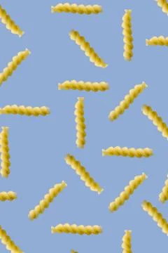 Fusilli pasta random flat lay on blue background without shadow. can be used  Stock Photos