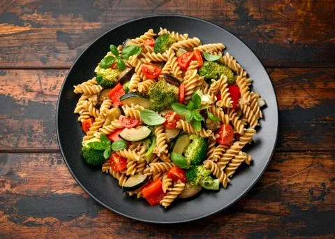 Fusilli pasta with vegetable, broccoli, zucchini, red pepper, eggplant, tomato Stock Photos