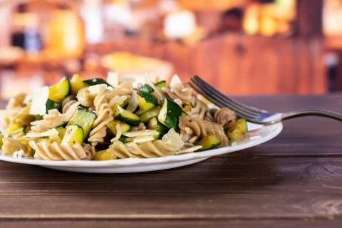 Fusilli pasta with zucchini with rustic kitchen 스톡 사진