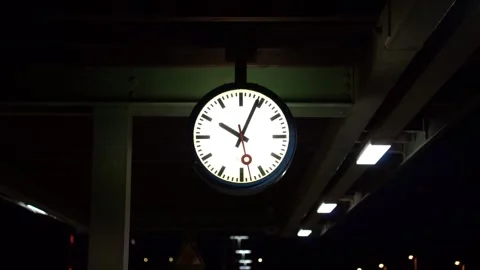 FUSSEN, GERMANY – Illuminated station clock at railway platform Stock Footage 343853430
