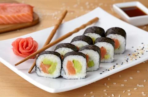 Futomaki sushi roll with salmon, avocado and nori Stock Photos